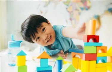 child playing with building blocks